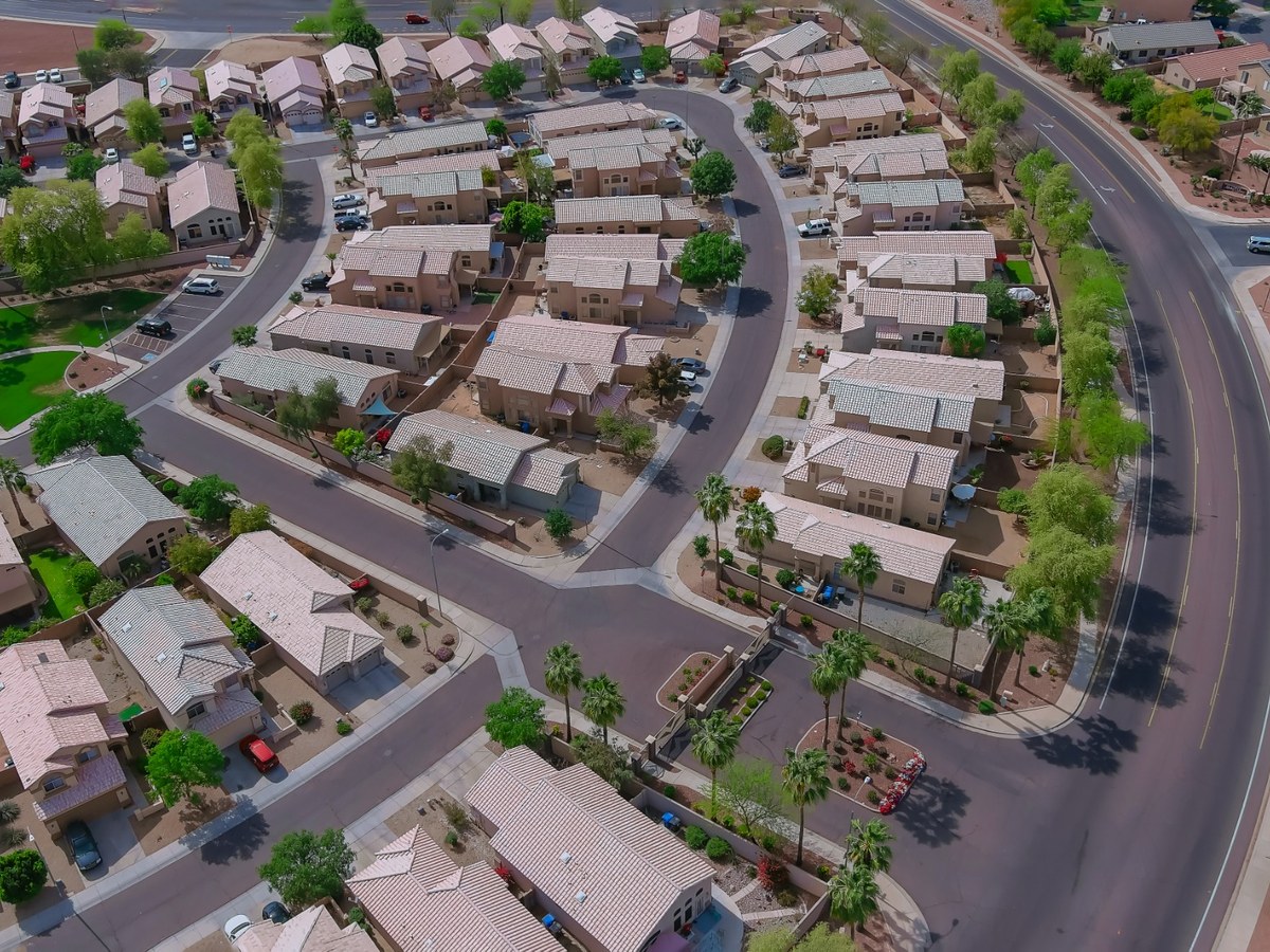 photovs210400033_1200x900_350kb Aerial view of a quiet suburban neighborhood in the East Valley, with similar stucco houses and curved streets, giving a clear sense of typical east valley home value.